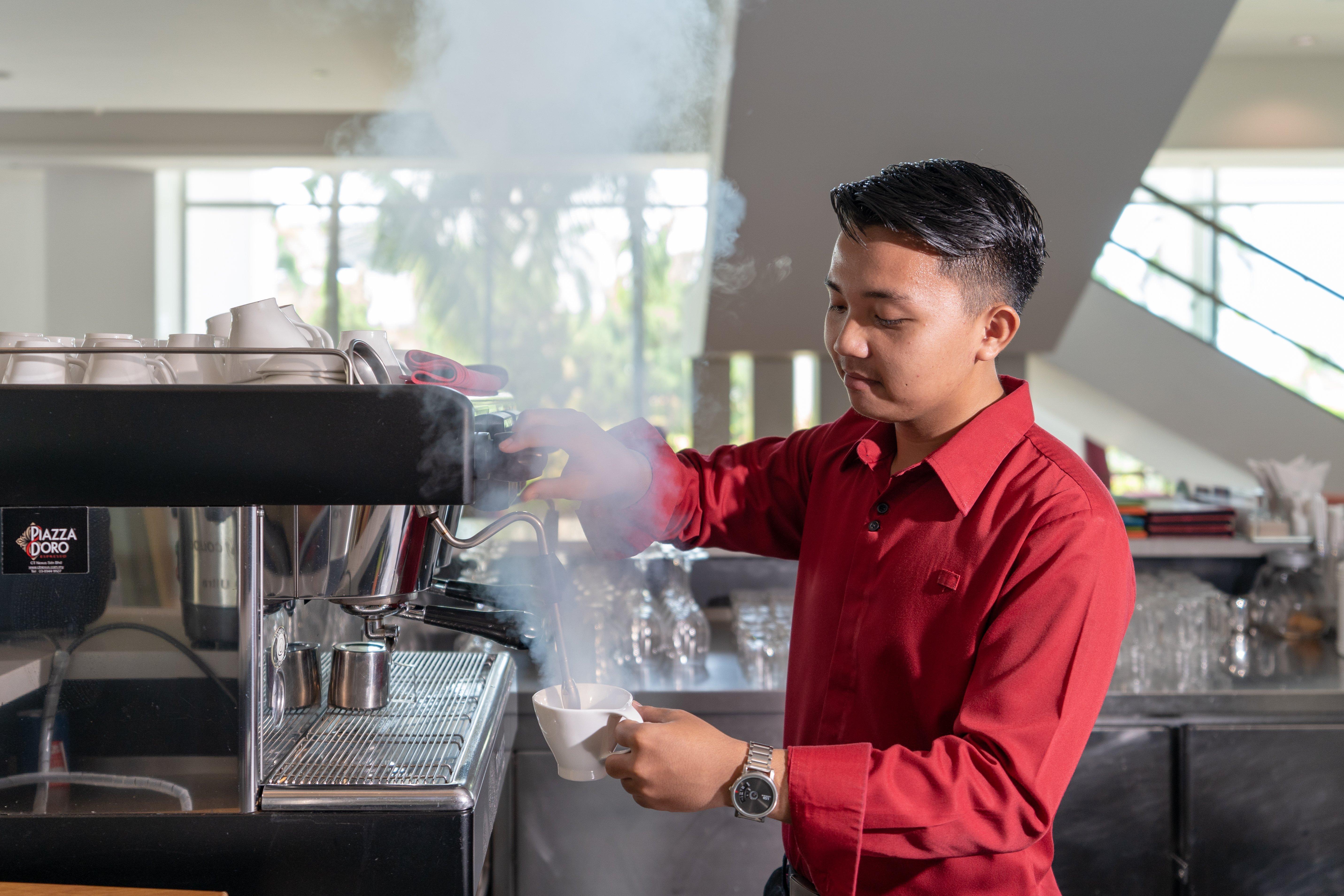 Holiday Inn Melaka By Ihg Kültér fotó A barista at work